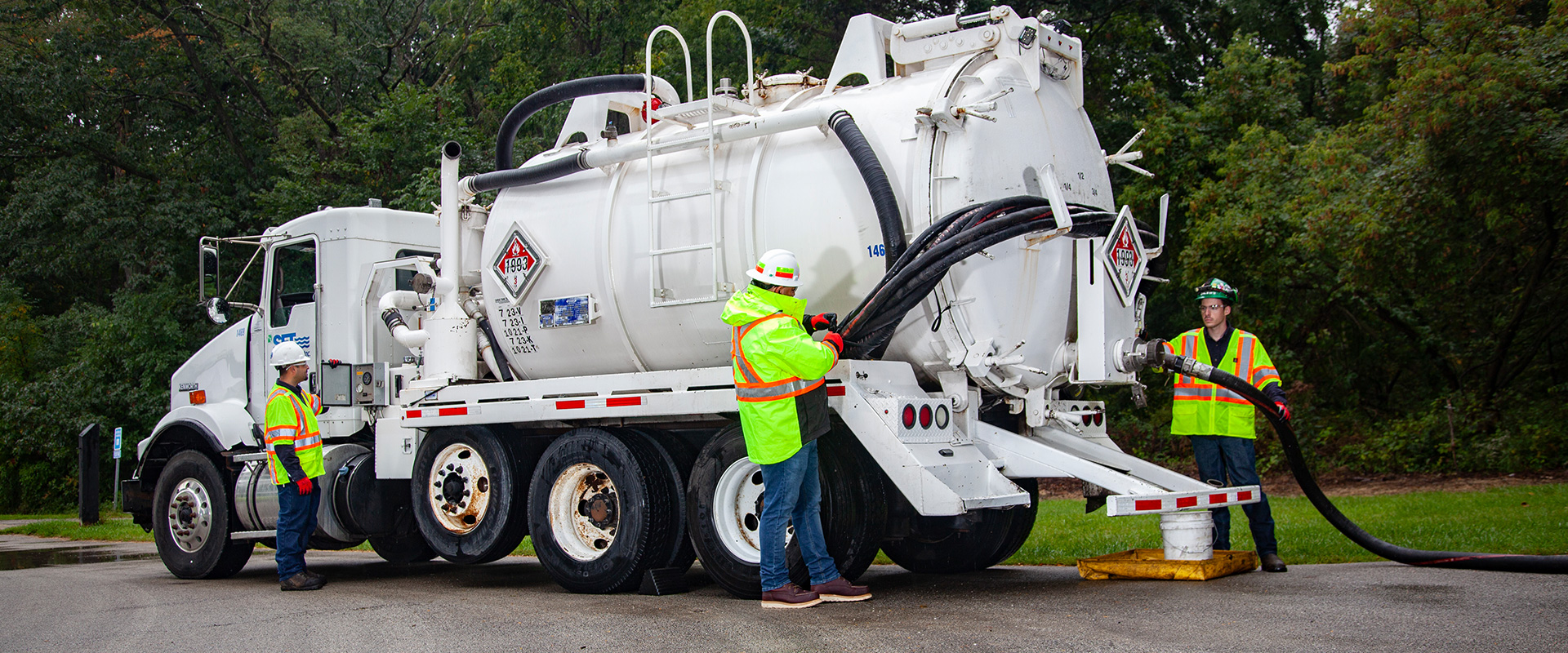 field service and emergency response workers by a white truck