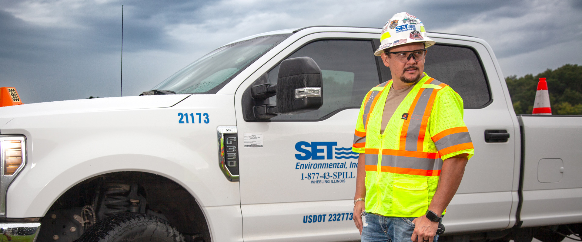 SET Environmental worker wearing safety hat, safety glasses, and safety vest