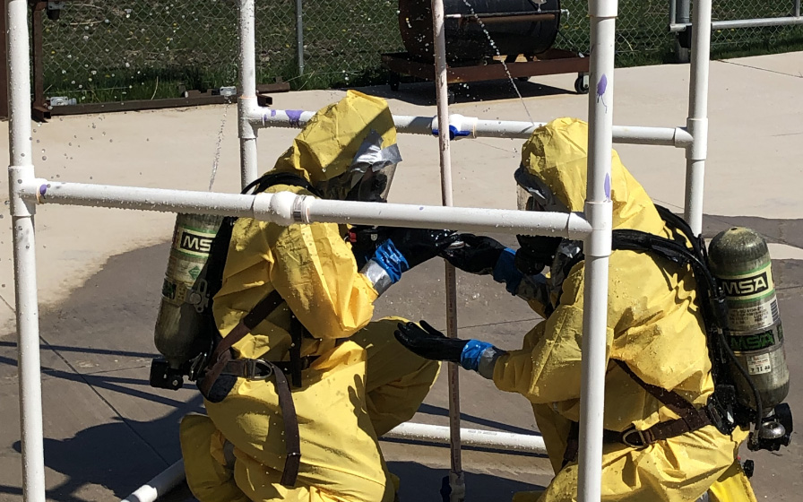 Safety training in yellow suits and oxygen masks