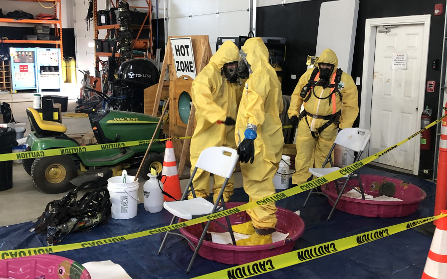 Safety training in yellow suits and oxygen masks