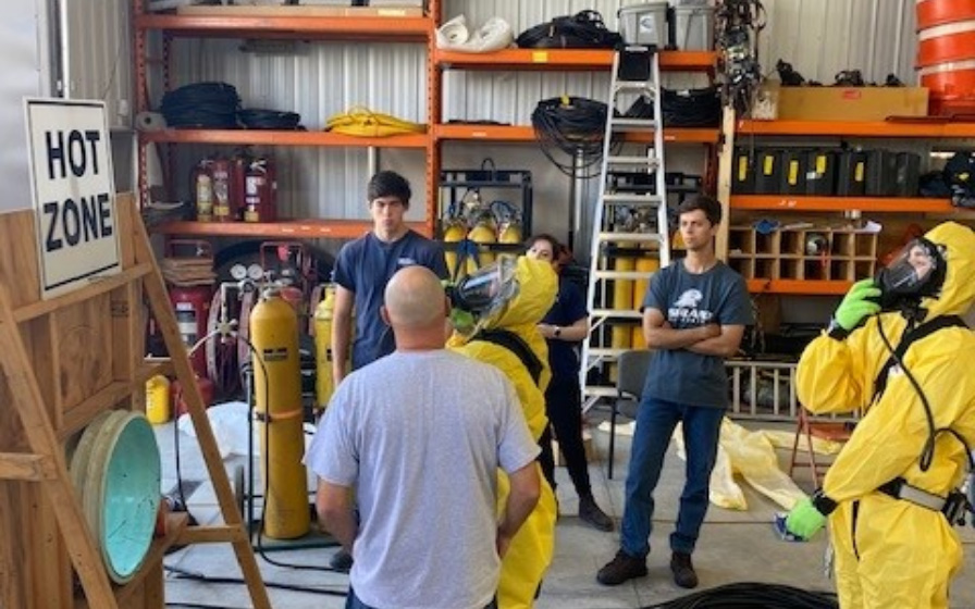 Safety training in yellow suits and oxygen masks