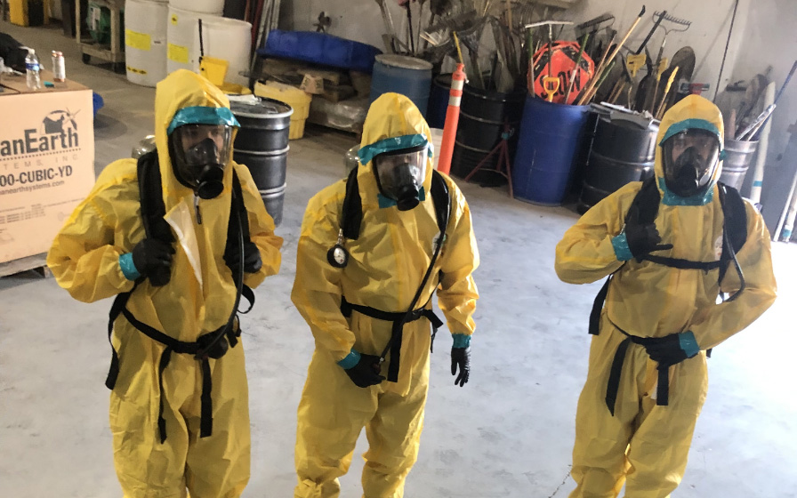 Safety training in yellow suits and oxygen masks