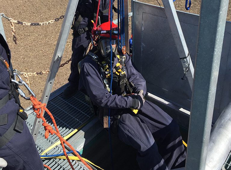 SET Environmental worker safely geared up in a suit and oxygen mask